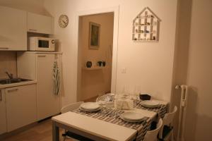 a kitchen with a table with plates and glasses on it at Casa Palladio in Vicenza