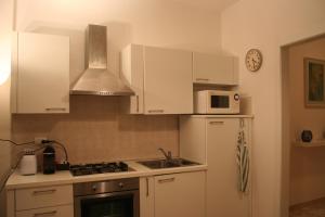 a kitchen with white cabinets and a sink and a microwave at Casa Palladio in Vicenza