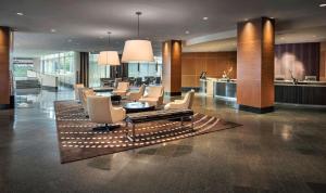 um lobby com um monte de cadeiras e uma mesa em Hyatt Regency Pittsburgh International Airport em Clinton