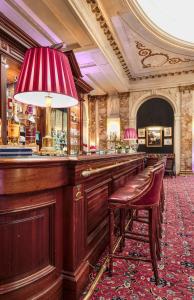 a bar in a building with a red carpet at Hotel Le Plaza Brussels in Brussels