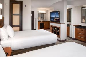 a hotel room with two beds and a flat screen tv at Hyatt Place Dallas/North Arlington/Grand Prairie in Arlington