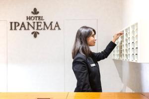 a woman standing in front of a hotel panama sign at Oca Ipanema Hotel in Vigo