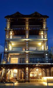 een hoog gebouw 's nachts met lichten bij Azure Beach Boutique Hotel in Grand Baie