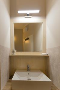 a bathroom with a sink and a mirror at Aurora Vendégház in Hévíz