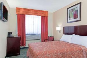 A bed or beds in a room at Super 8 by Wyndham Long Island City LGA Hotel