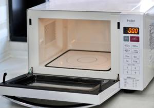 a white microwave oven sitting on top of a counter at Hotel JIN Morioka Ekimae in Morioka