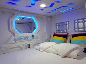 A bed or beds in a room at Galaxy Pods @ Chinatown