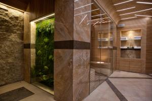 a walk in shower with a fish tank at Boutique Hotel La Roche in Tivat