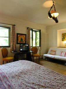 a bedroom with a bed and a couch at Haus Wartenberg in Salzburg