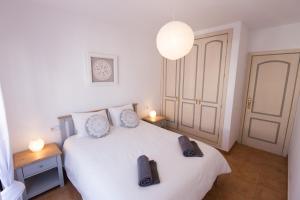 a bedroom with a white bed with two pillows on it at Surfers Retreat in Corralejo