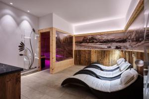 a bathroom with a large mattress on the floor at Hotel Garni Savoy in Castelrotto