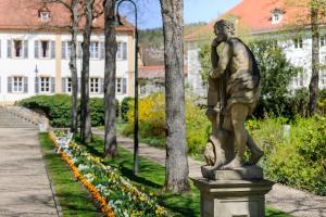 une statue d'un homme debout dans un parc dans l'établissement Hotel Kurhaus Bad Bocklet, à Bad Bocklet