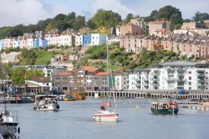 a group of boats in a body of water with buildings at YHA Bristol in Bristol