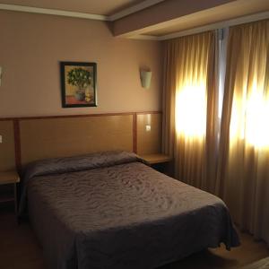 Ліжко або ліжка в номері Hotel Avenida Leganés