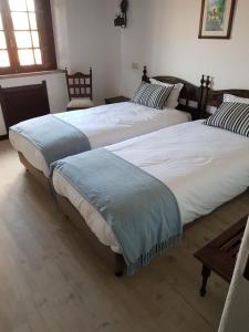 dos camas sentadas una al lado de la otra en un dormitorio en Rainha Santa Isabel - Óbidos History Hotel, en Óbidos