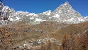 a mountain with a village in the middle of it at Residence Redicervinia in Breuil-Cervinia