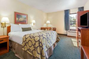 a hotel room with a bed and a flat screen tv at Baymont by Wyndham Amarillo East in Amarillo