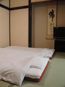 Una cama o camas en una habitación de Kiyoshigekan