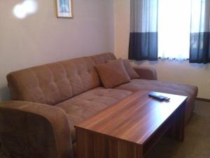 a living room with a couch and a wooden coffee table at Statek Kloubek in Chabičovice