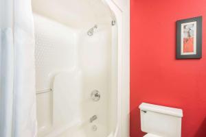 een badkamer met een witte douche en een wit toilet bij Ramada by Wyndham Springfield North in Springfield