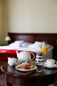 a table with a tea set on top of a bed at Turówka Hotel & Spa in Wieliczka