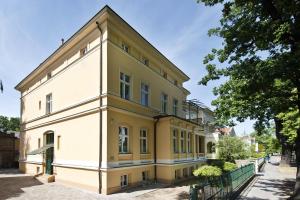 a yellow and white building on a street at Guest house Villa Fritz in Potsdam