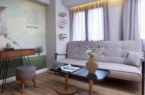 a living room with a couch and a table at Apollon Library Suites in Nafpaktos