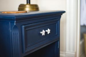 a blue dresser with two butterflies on it at Salt Shaker Deli & Inn in Lunenburg