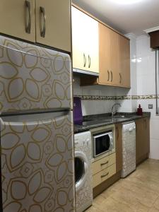 A kitchen or kitchenette at Apartamentos Costa Noja