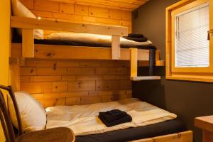 a room with three bunk beds and a chair at Chalet Schtuba in Zermatt