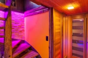 a room with purple and pink lights on the stairs at Chalet Schtuba in Zermatt