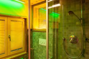 a shower in a bathroom with green tile at Chalet Schtuba in Zermatt