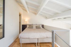 1 dormitorio con 1 cama en una habitación blanca en Effetto Cittadella, en Lucca