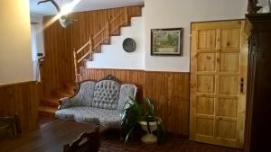 a living room with a chair and a staircase at Penzion Kalina in Tábor