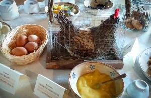 a table with a bowl of soup and a basket of eggs at Masseria Torricella in Alberobello