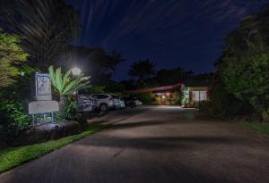 a driveway leading to a garage at night at Kookaburra Motel Yungaburra in Yungaburra