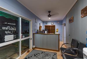 a room with a counter and a table and chairs at Kookaburra Motel Yungaburra in Yungaburra