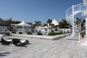 a rendering of a resort with a staircase and chairs at Female Resort in San Felice Circeo