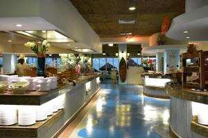 a restaurant with white plates on the counter in the middle at Crown Paradise Club All Inclusive in Puerto Vallarta