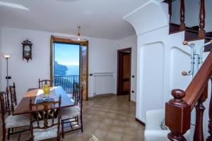 een eetkamer met een tafel en een balkon bij Casa Rossa in Ravello