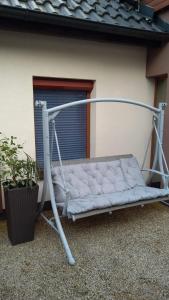 a swing bed in front of a building at Apartman Za Potokem in Luhačovice