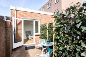 um pequeno pátio com uma mesa e uma planta em Lou-Lou em Zandvoort