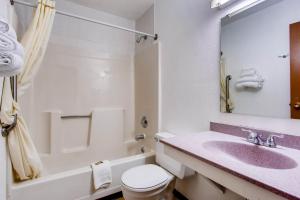 a bathroom with a sink and a toilet and a tub at 9 Motel in Fort Collins