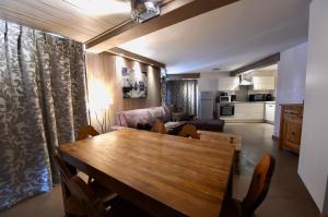 a living room with a wooden table and a couch at A21 Roc de Péclet in Val Thorens