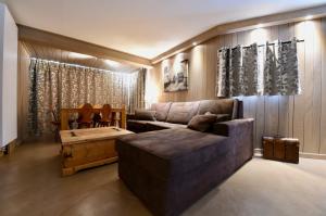 a living room with a couch and a coffee table at A21 Roc de Péclet in Val Thorens