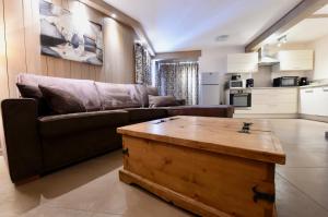 a living room with a couch and a coffee table at A21 Roc de Péclet in Val Thorens