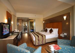 a hotel room with a bed and a television at The Golkonda Hotel in Hyderabad