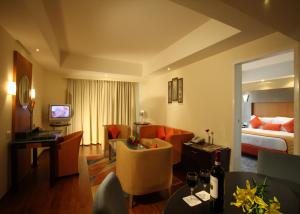 a hotel room with a bed and a living room at The Golkonda Hotel in Hyderabad