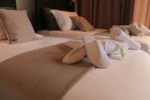 a pair of shoes sitting on top of a bed at Calypso Home Oran in Oran