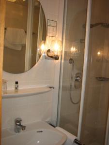 a bathroom with a shower and a sink and a toilet at BSW Ferienhotel Lindenbach in Bad Ems